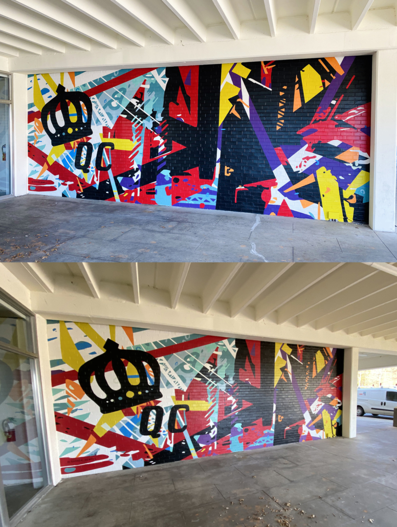 Energetic mural of geometric shapes & abstracted trusses & beams in bold colors on brick wall. Charlotte NC’s crown logo and QC painted prominently in black on left side of mural. Located outside Bart’s Bottle Shop, Eastway Shopping Center.