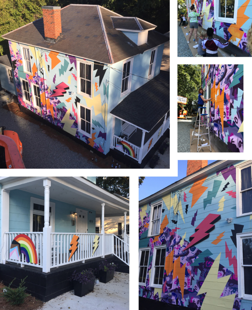 A colorful, two-story, hand-painted mural of comic book-style lightning bolts & playful shapes & lines covering the entire exterior wall of Girls Rock CLT headquarters. Summer camp volunteers and youth also helped create the inclusivity rainbow and painted, aluminum lighting bolt sculptures on front porch railing.