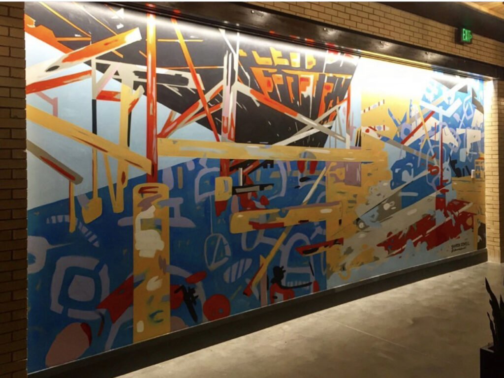 9' x 22' abstract, asymmetrical mural in 3 quadrants with linear design resembling deconstructed bridge trellis in upper left quadrant. Bold fire colors, cool blues, grays and black. In the elevator lobby of The Refinery, a luxury office building in Charlotte.